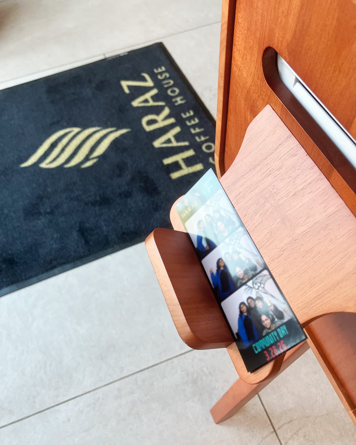 Firstlight photobooth printed photo strip beside branded event details